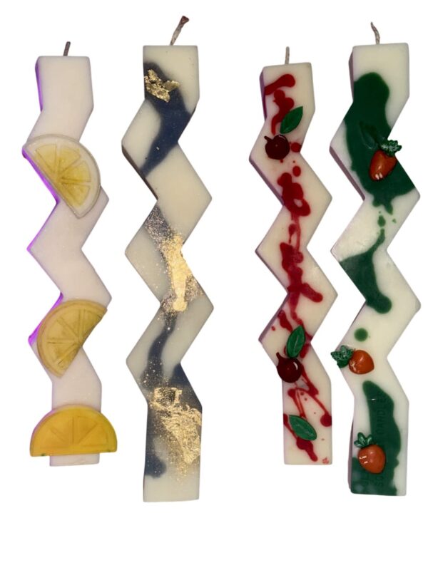 Handcrafted zig-zag soy wax Easter candles with decorative fruit and botanical designs